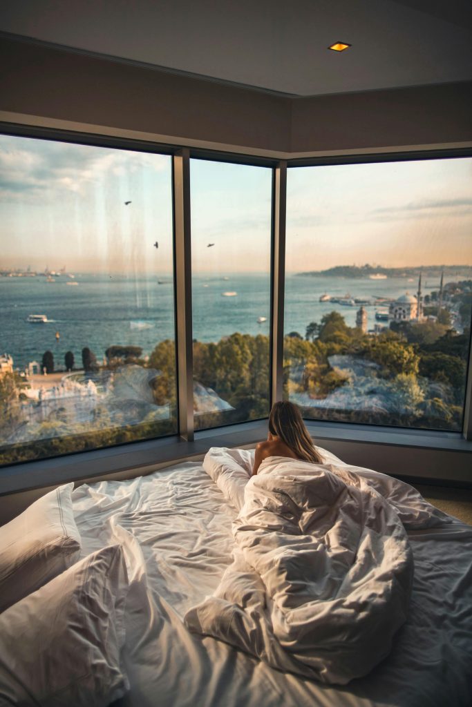 pexels photo 2417842 2417842 Relaxing in a cozy hotel room with stunning views of the Bosphorus at sunset in Istanbul, Turkey.