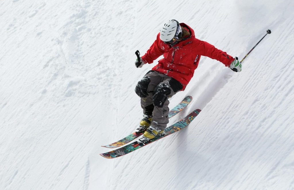 freerider skiing ski sports 47356 47356 A skier in a red jacket descends a steep snowy slope, showcasing skill and adventure in winter sports.