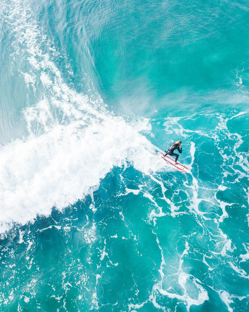 pexels photo 4784230 4784230 A thrilling aerial shot capturing a surfer expertly navigating turquoise ocean waves.